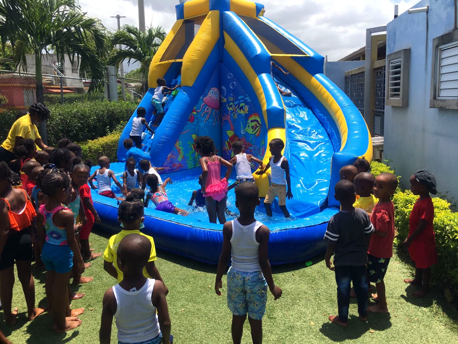 Children splashing in a WildRides water slide pool